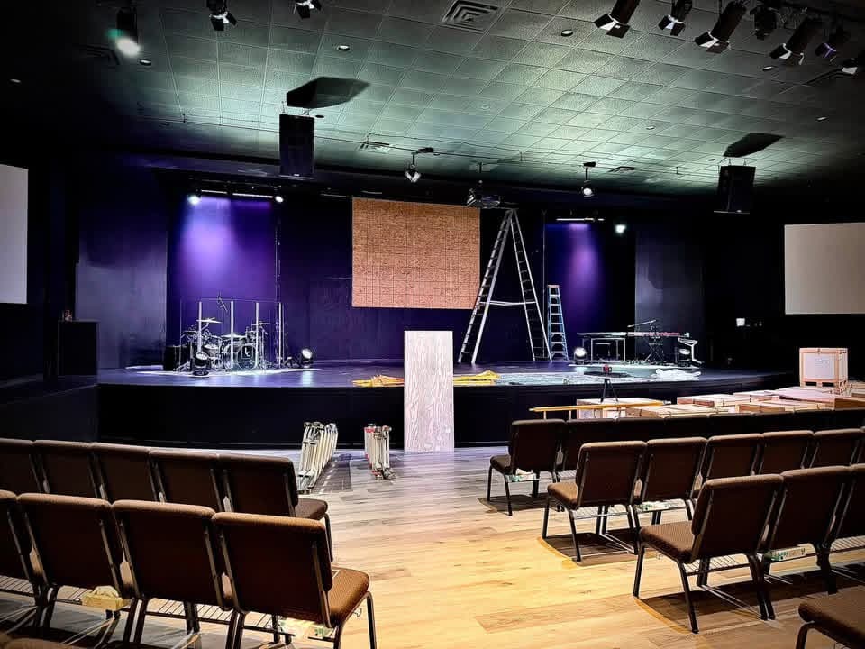 Before shot of the stage at Life Church in Danville, Illinois, with a plywood mock-up wall and ladders during LED wall installation